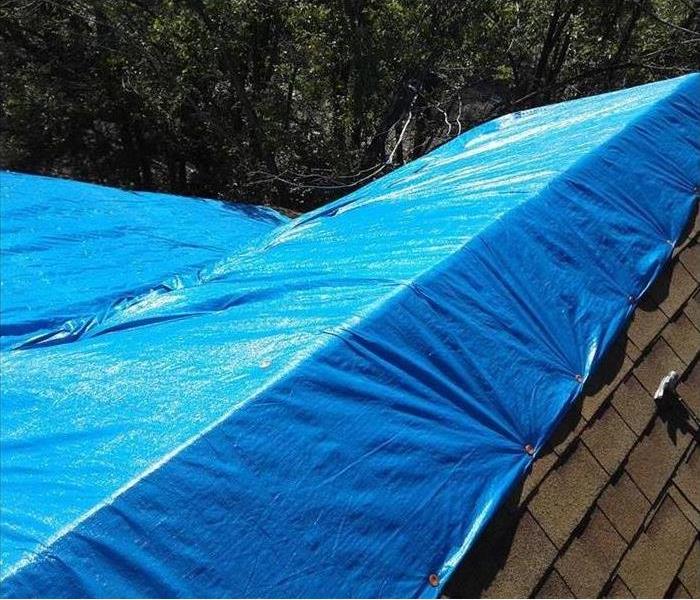 Same roof with tarp covering potential leaks