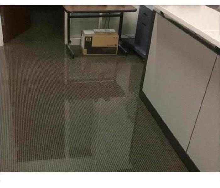 Office floor showing inches of water flooding