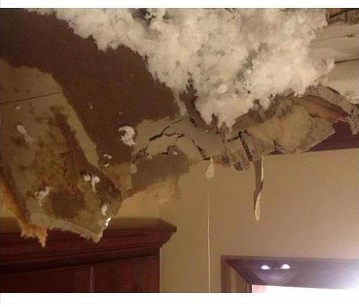 Ceiling with hole and insulation falling through