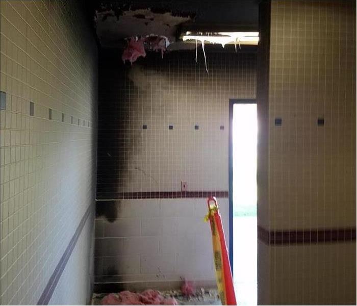 School bathroom showing considerable soot and fire damage